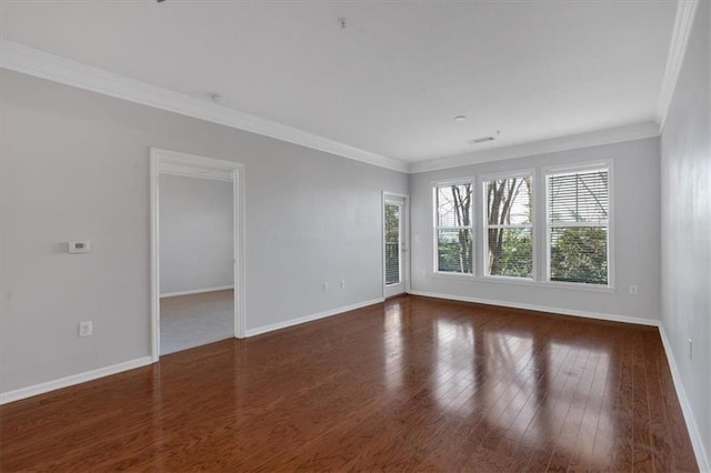 spare room with ornamental molding and dark hardwood / wood-style flooring