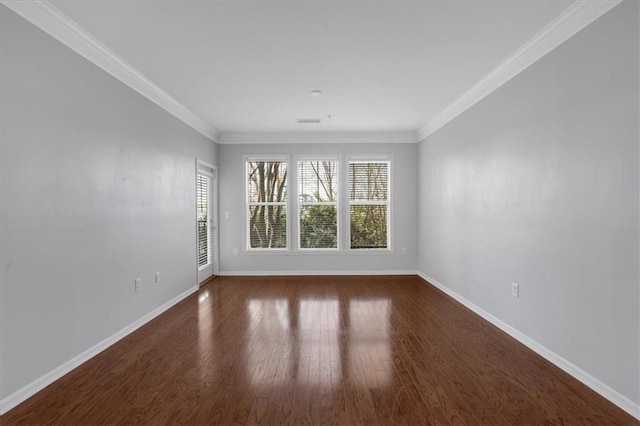 spare room with dark hardwood / wood-style flooring and crown molding