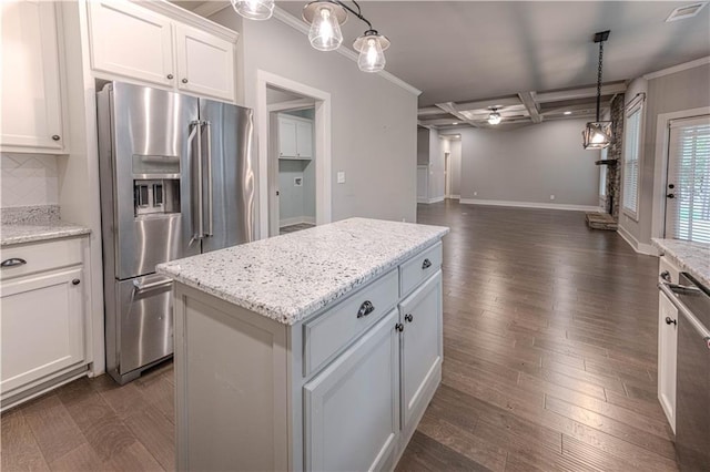 kitchen featuring coffered ceiling, stainless steel appliances, beam ceiling, a center island, and white cabinetry