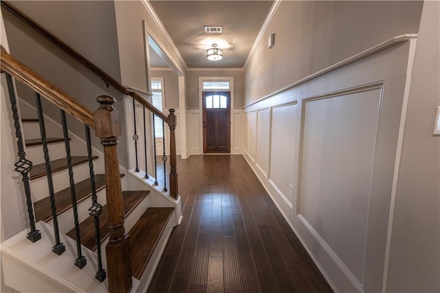 doorway with crown molding and dark hardwood / wood-style flooring