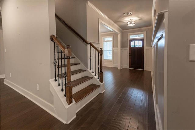 entryway featuring dark hardwood / wood-style flooring and crown molding