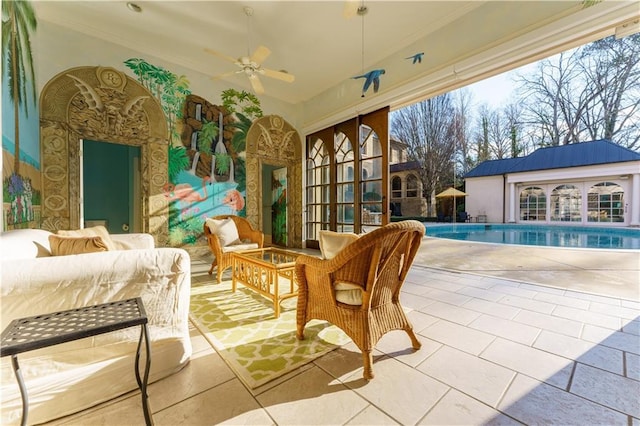 sunroom / solarium featuring ceiling fan