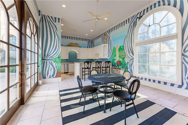 sunroom featuring ceiling fan