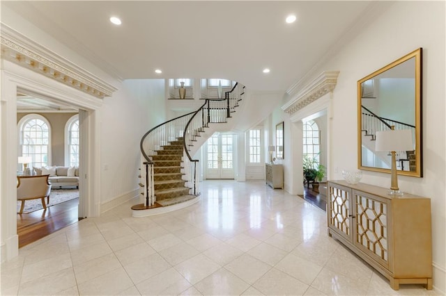 entrance foyer with ornamental molding and light tile patterned floors