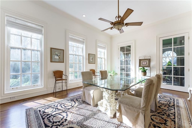 dining room featuring crown molding, wood-type flooring, and ceiling fan