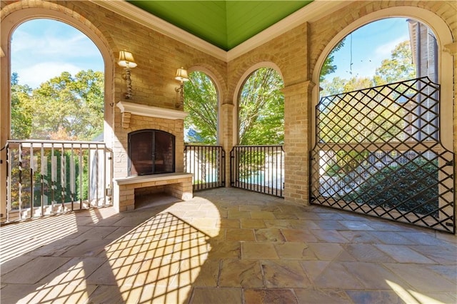 view of patio with an outdoor brick fireplace