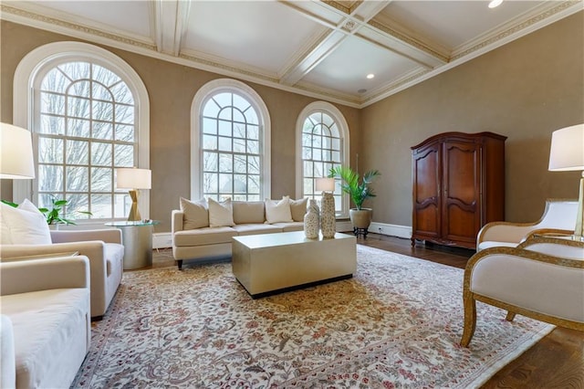 living area featuring wood-type flooring, plenty of natural light, coffered ceiling, and beam ceiling