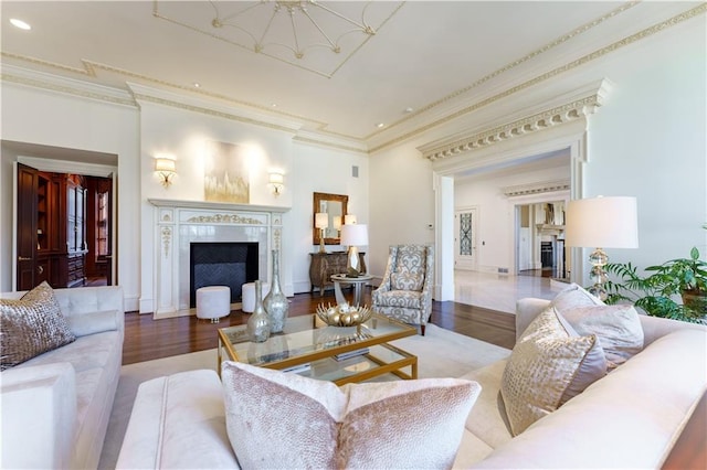 living room with crown molding, hardwood / wood-style flooring, and a fireplace