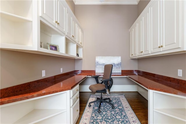 home office with crown molding, dark hardwood / wood-style floors, and built in desk