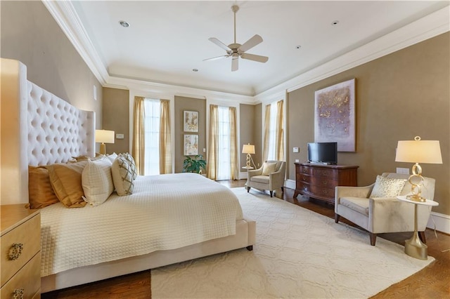 bedroom featuring crown molding, hardwood / wood-style flooring, and ceiling fan