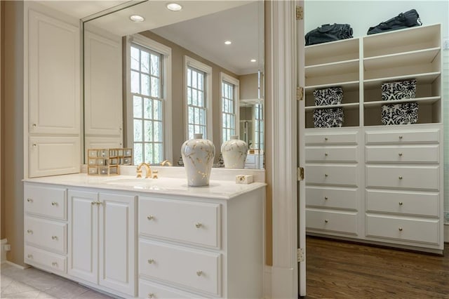 bathroom featuring vanity and ornamental molding