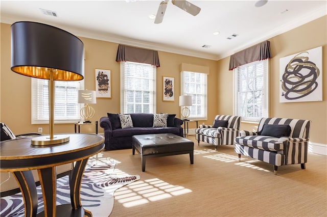 living room featuring ornamental molding and ceiling fan