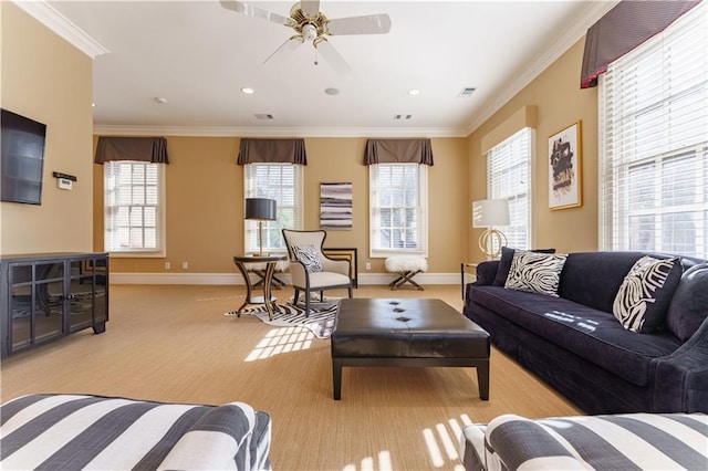 living room with ornamental molding, plenty of natural light, and ceiling fan