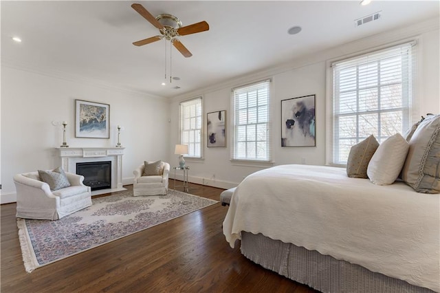 bedroom featuring crown molding, ceiling fan, and dark hardwood / wood-style floors