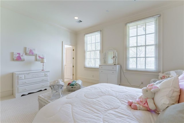 carpeted bedroom with multiple windows and ornamental molding