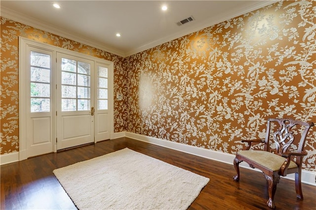 entryway with ornamental molding and dark hardwood / wood-style floors