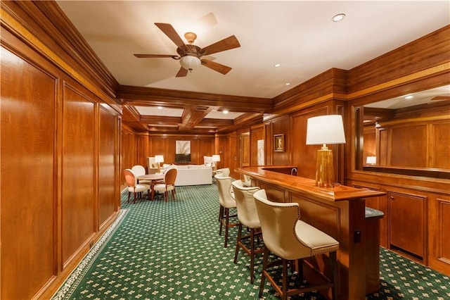 bar with dark colored carpet, coffered ceiling, wood walls, and decorative light fixtures