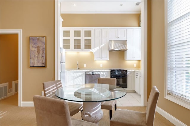 dining space featuring sink and crown molding