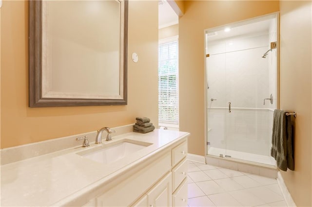 bathroom featuring a shower with door, vanity, tile patterned floors, and crown molding