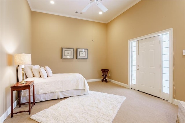 carpeted bedroom with ornamental molding and ceiling fan