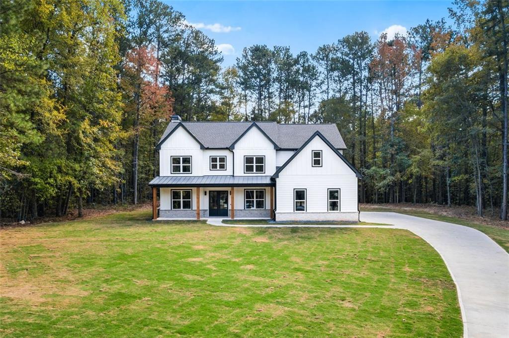 view of front of home with a front yard and a porch