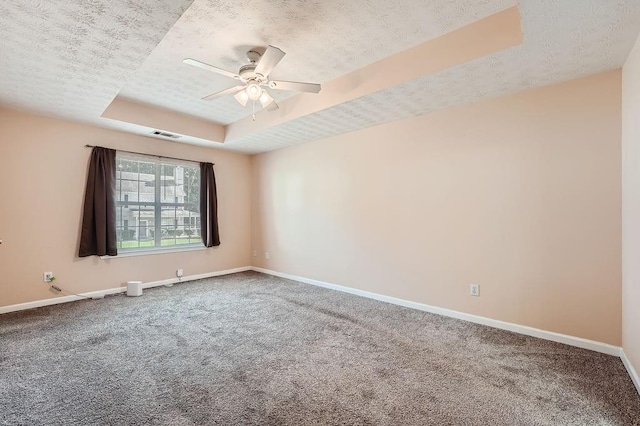 unfurnished room featuring baseboards, a ceiling fan, a raised ceiling, and carpet