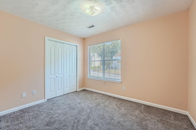 unfurnished bedroom featuring carpet floors, baseboards, and visible vents