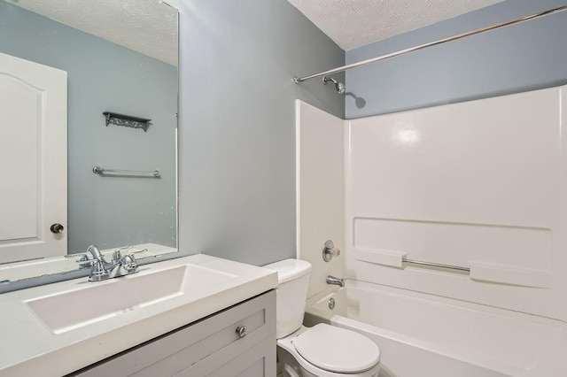 full bathroom featuring vanity, a textured ceiling, shower / bathtub combination, and toilet
