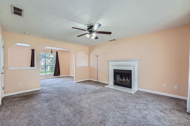 unfurnished living room featuring a ceiling fan, a textured ceiling, visible vents, and carpet