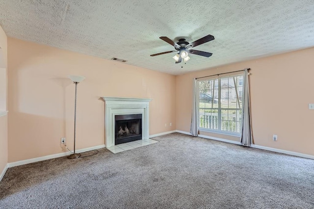 unfurnished living room with visible vents, carpet floors, a fireplace with flush hearth, a textured ceiling, and a ceiling fan
