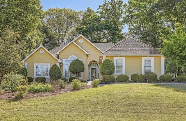 184 Glenn Eagles Way, Hiram, GA 30141 - traditional home with stucco siding, a front yard, and roof with shingles