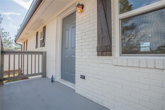 view of side of property featuring brick siding