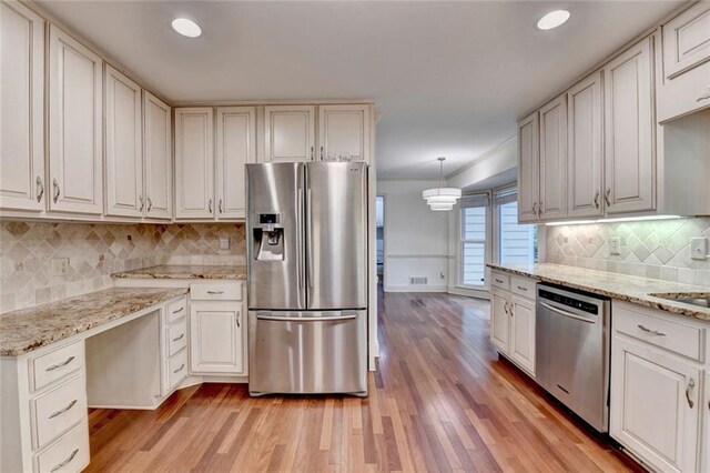 5507 Martina Way, Dunwoody, GA 30338 - kitchen with appliances with stainless steel finishes, light wood finished floors, tasteful backsplash, baseboards, and light stone countertops