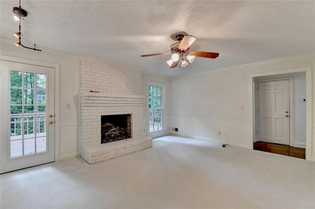 5507 Martina Way, Dunwoody, GA 30338 - unfurnished living room featuring carpet flooring, ceiling fan, a wainscoted wall, and a fireplace