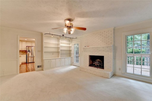 5507 Martina Way, Dunwoody, GA 30338 - unfurnished living room with ceiling fan, light carpet, a textured ceiling, ornamental molding, and a fireplace