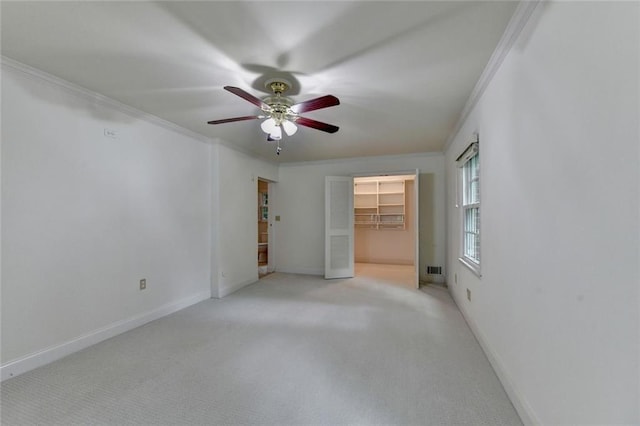 5507 Martina Way, Dunwoody, GA 30338 - unfurnished bedroom featuring ornamental molding, carpet floors, a walk in closet, baseboards, and a ceiling fan