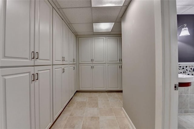 5507 Martina Way, Dunwoody, GA 30338 - hallway with light tile patterned floors, baseboards, and a paneled ceiling