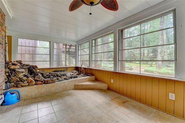 5507 Martina Way, Dunwoody, GA 30338 - unfurnished sunroom with healthy amount of natural light, tile patterned floors, and wood walls