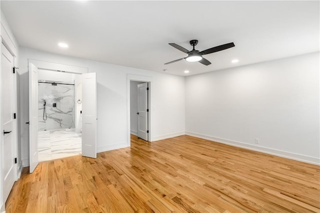 unfurnished bedroom featuring light hardwood / wood-style flooring, ceiling fan, and ensuite bathroom