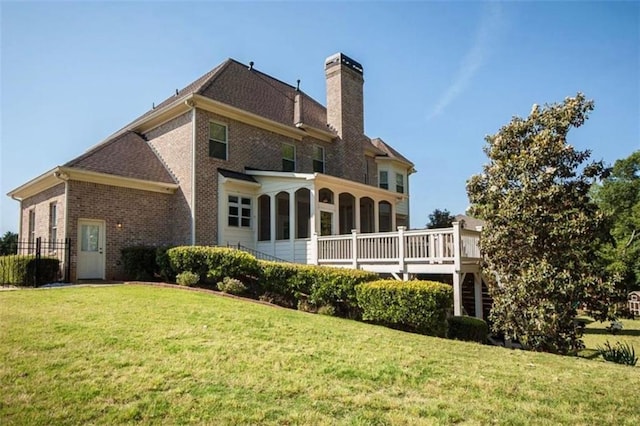 back of house with a yard and a wooden deck