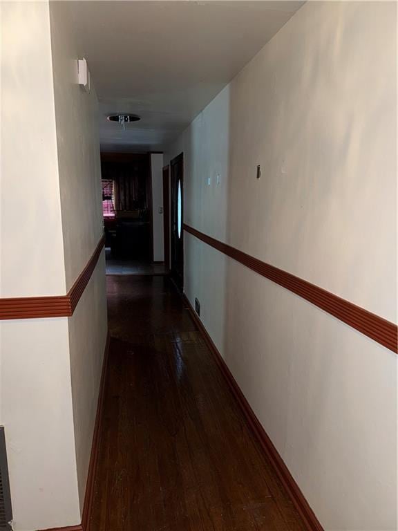 hall with dark wood-style flooring