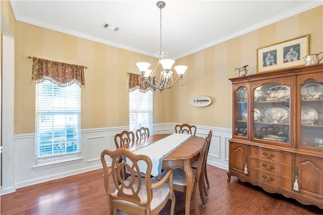 dining area with plenty of natural light, visible vents, and wainscoting