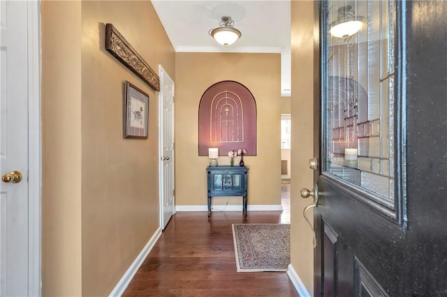 foyer with baseboards, dark wood-style floors, and crown molding