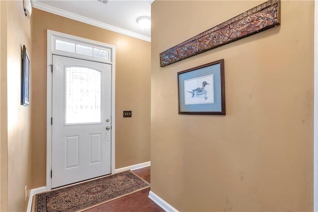 foyer entrance featuring crown molding, dark wood-style floors, and baseboards