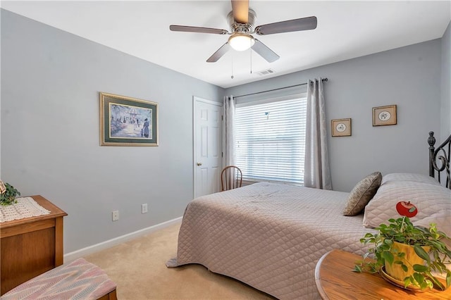 bedroom featuring ceiling fan, baseboards, visible vents, and light carpet