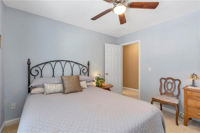 bedroom featuring a ceiling fan, visible vents, light colored carpet, and baseboards