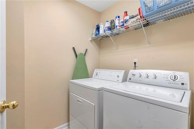 laundry area featuring washer and clothes dryer, laundry area, and baseboards