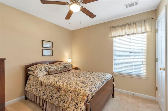 bedroom with light colored carpet, visible vents, and baseboards