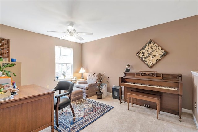 home office with light carpet, baseboards, and ceiling fan