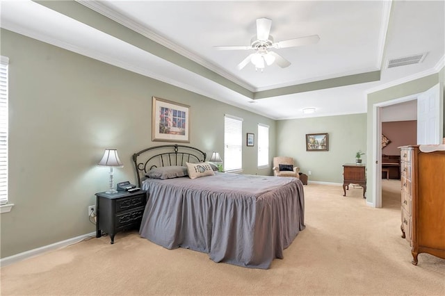 bedroom featuring visible vents, a raised ceiling, light colored carpet, and baseboards